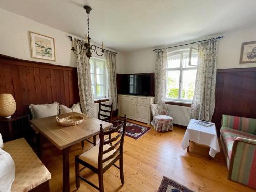 a living room with a table and a couch at Cottage am Attersee in Nussdorf am Attersee