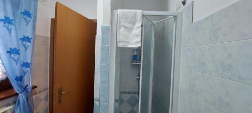 a shower with a glass door in a bathroom at La Casa di Alberto in Camerino