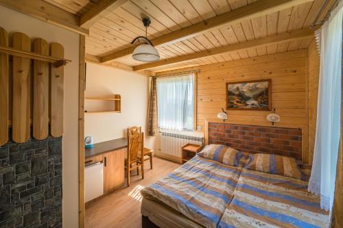 a bedroom with a bed and a desk at Ośrodek Wypoczynkowy Bernadetta in Murzasichle