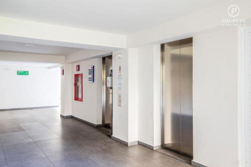 an empty hallway with elevators in a building at Harbor Puerto Vallarta 1006 in Puerto Vallarta