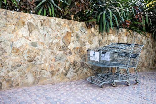 a shopping cart sitting in front of a stone wall at Harbor Puerto Vallarta 1006 in Puerto Vallarta