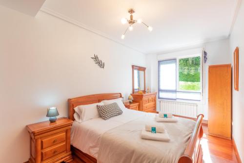 a bedroom with a bed with two trays on it at Sabea - Baskey Rentals in Iraeta