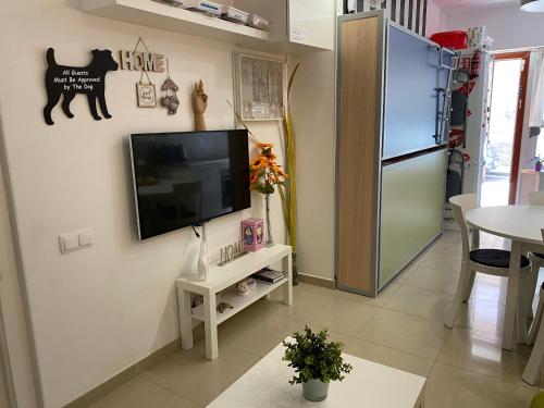 a living room with a flat screen tv on a wall at BADAROSA 2 House10min to BARCELONCity&NearTo BEACH in Badalona