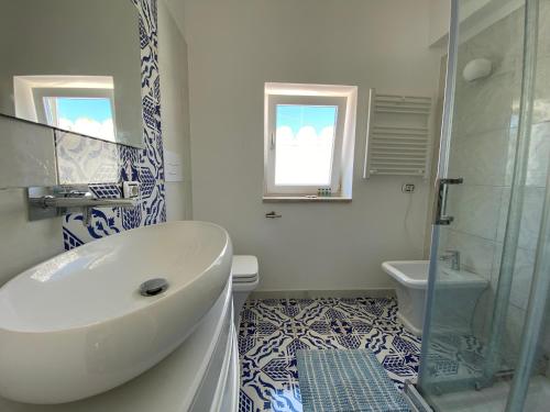 a bathroom with a tub and a sink and a toilet at Villa Raffaella in Capri