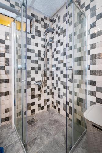 a bathroom with a glass shower and a sink at Apartman Best in Novigrad Dalmatia