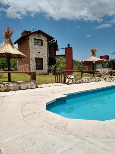 una piscina frente a una casa en Cabañas Aires de Montaña en 