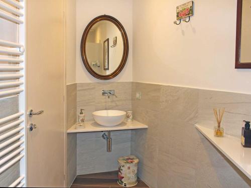 a bathroom with a sink and a mirror at Villa Rubino Apartment con giardino e jacuzzi vista lago in Stresa
