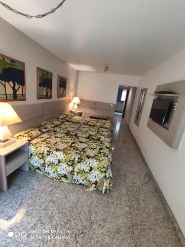 a bedroom with a bed with flowers on it at Royalty Copacabana Hotel in Rio de Janeiro