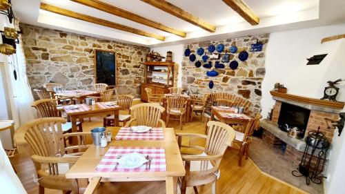 a restaurant with wooden tables and chairs and a fireplace at Penzion Valkoun-Lilienfeld in Karlovy Vary