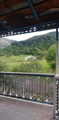 a balcony with a view of a golf course at Guesthouse Leno in Tsaldashi