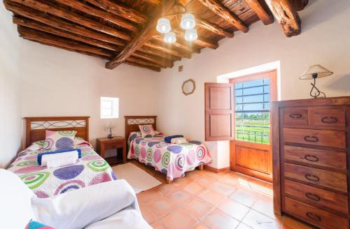 a bedroom with two beds and a window at CAN FARITZEO in Sant Rafael de Sa Creu