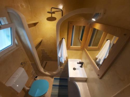 a small bathroom with a sink and a mirror at 2022 RENOVATED apartment on the beach in Poljana