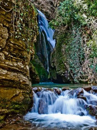 a waterfall in the middle of a river at ΕΚΑLI ROOMS APARTMENTS in Kalentzi