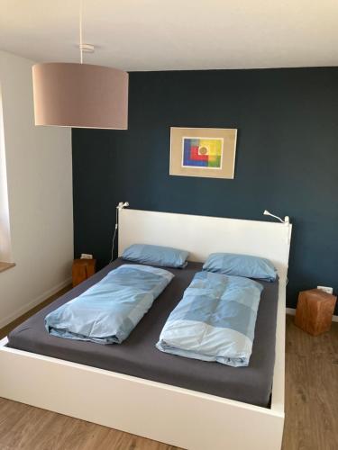 a bed with two pillows on it in a bedroom at Strand24 in Ostseebad Nienhagen