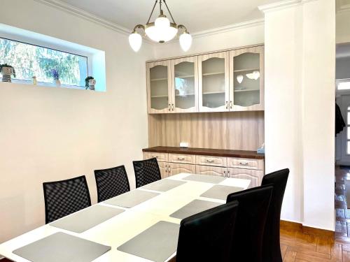 a dining room with a table and chairs at Holiday home with Jakuzzi and Sauna in Kisoroszi