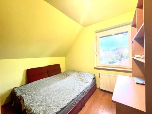 a small bedroom with a bed and a window at Holiday home with Jakuzzi and Sauna in Kisoroszi