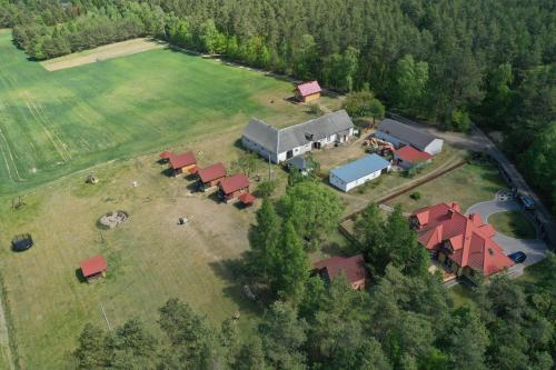 an aerial view of a farm with a group of buildings at Samosiejka - z widokiem na jezioro in Lidzbark