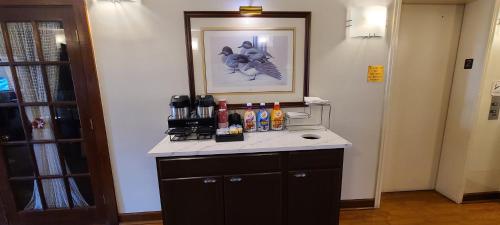 a room with a counter with alcohol bottles on it at Red Roof Inn & Suites Cornelius - Lake Norman in Cornelius