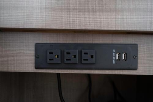 an electronic clock on a shelf in a bathroom at Red Roof Inn & Suites Cornelius - Lake Norman in Cornelius