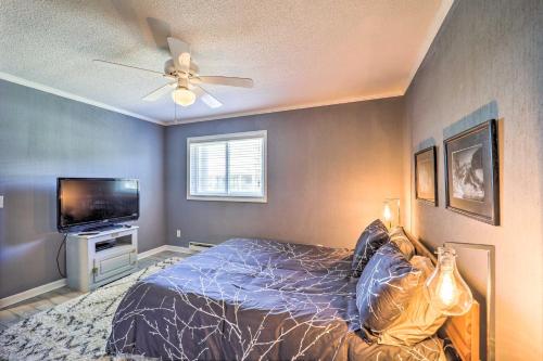 a bedroom with a bed and a flat screen tv at 2 Mi to Skiing! Beech Mtn Condo with Resort Perks in Beech Mountain