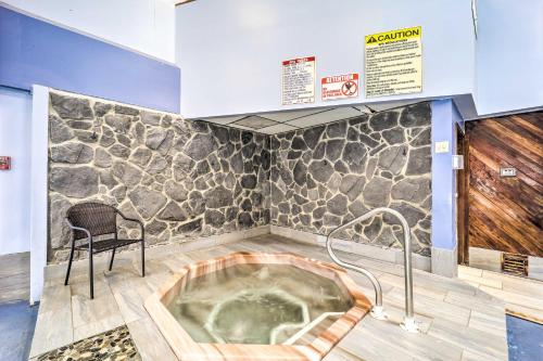 a jacuzzi tub in a room with a chair at 2 Mi to Skiing! Beech Mtn Condo with Resort Perks in Beech Mountain