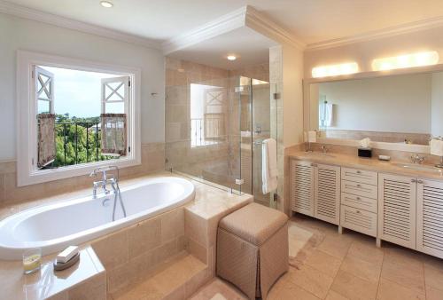 a large bathroom with a tub and a window at Sweet Dream Villa with Private Pool in Sugar Hill! in Saint James