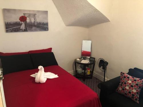 a stuffed animal on a red bed in a room at A Hidden Gem, approx 15 mins to downtown Chicago! in Chicago