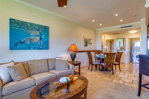 a living room with a couch and a table at Kapalua Extraordinaire with Glorious Ocean Views! in Kahana