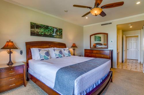 a bedroom with a bed and a ceiling fan at Kapalua Extraordinaire with Glorious Ocean Views! in Kahana