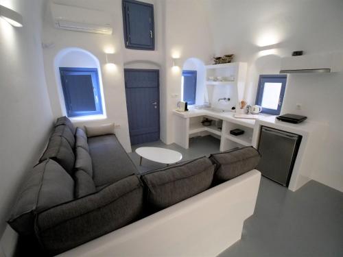 a living room with a couch and a kitchen at Oinos Luxury Suites in Foinikiá