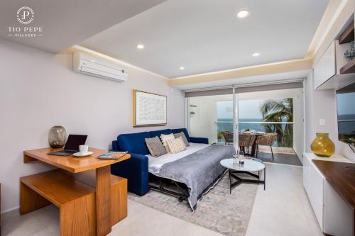 a living room with a blue couch and a table at Harbor Puerto Vallarta 5009 in Puerto Vallarta