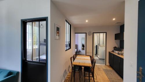une salle à manger et une cuisine avec une table et des chaises dans l'établissement Escapade à Lourdes dans T2 Bis proche Gare et Centre ville, à Lourdes