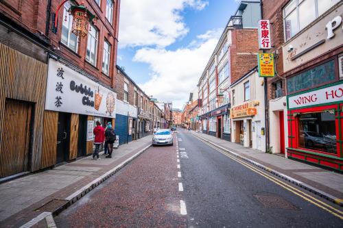 a street with a car parked on the side of the road at Apartment Chinatown 303 in Newcastle upon Tyne