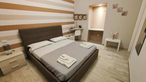 a bedroom with a bed with two towels on it at Sicily in Love - Rooms & Breakfast in Taormina