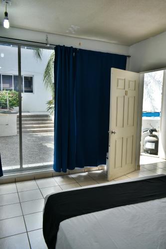 a bedroom with a blue curtain and a door at 10 VENATOR House Boutique in León