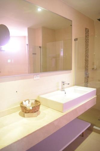 a bathroom with a sink and a mirror at Radisson Diamond Barranquilla in Barranquilla