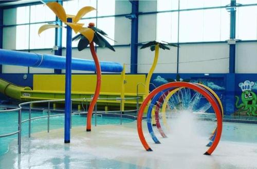 a pool with a water slide in a gym at PG177 Golden Palm Resort 8 Berth Caravan With Decking in Chapel Saint Leonards