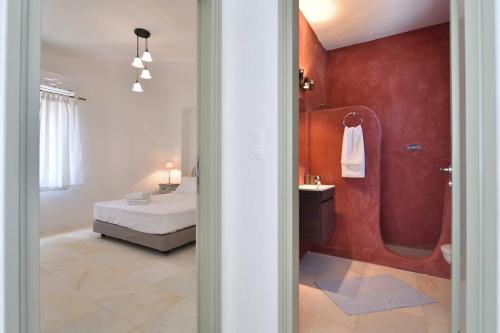 a bedroom with a bed and a bathroom with a shower at White house with sea view (number 2) in Ambelas