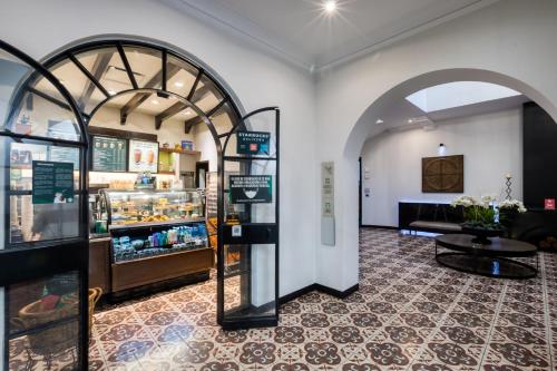 a store with an archway and a table in a room at AR 218 Hotel by ULIV in Mexico City
