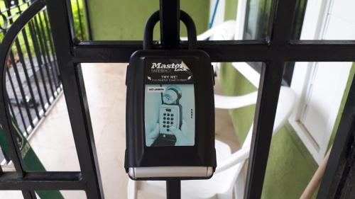 a cell phone is hanging on a gate at Seaview Villa at Stonebrook Manor in Falmouth