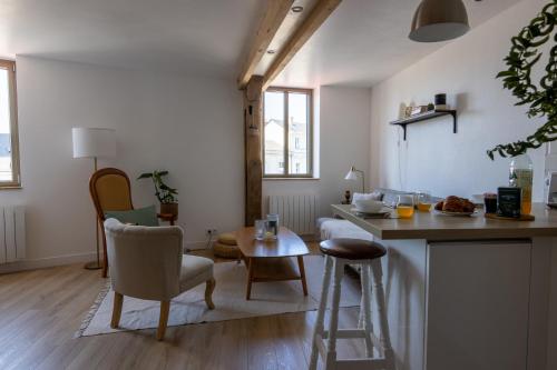 une cuisine et un salon avec une table et des chaises dans l'établissement APPARTEMENT DUPLEX SAUMUR CENTRE, refait à neuf, à proximité du château, à Saumur