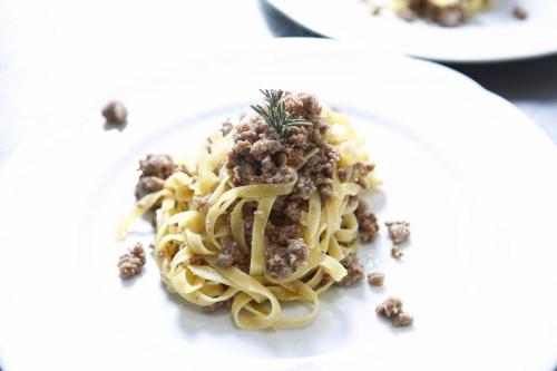 a plate of pasta with meatballs on a white plate at Hotel Il Cammino Di Francesco in Bastia Umbra