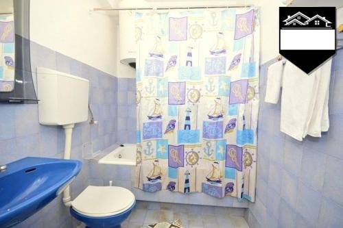 a bathroom with a toilet and a shower curtain at Apartment Jelka in Herceg-Novi