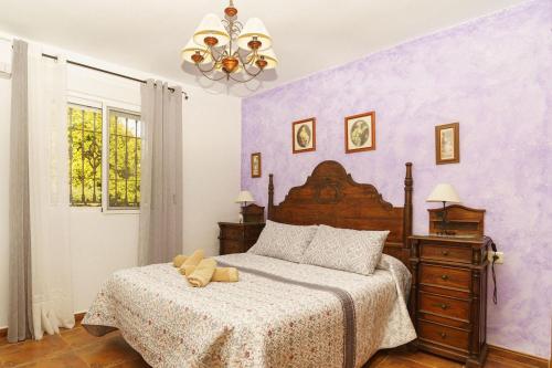 a bedroom with a bed with a teddy bear on it at Villa Triana in Nerja