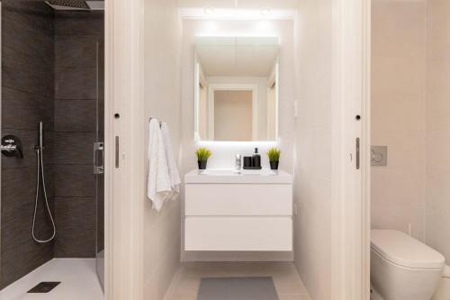 a white bathroom with a sink and a shower at The best apartament in Orihuela Costa