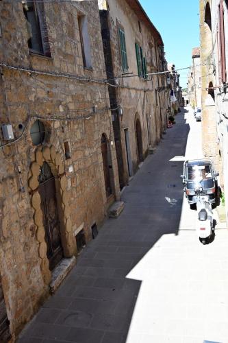 an alley with a motorcycle parked next to a building at il Cantuccio in Pitigliano