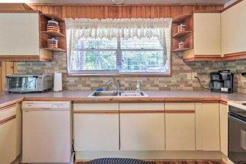 a kitchen with a sink and a window at Charming Abode with Dock on the Suwannee River in Bell