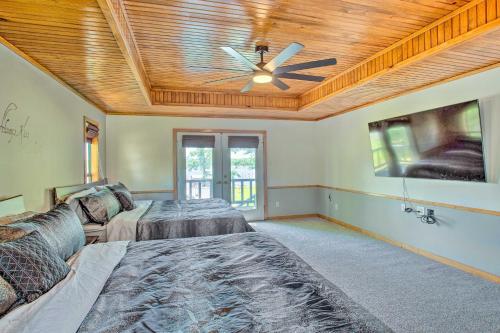 a bedroom with two beds and a ceiling fan at Waterfront Yantis Retreat with Deck and Zipline! in Yantis