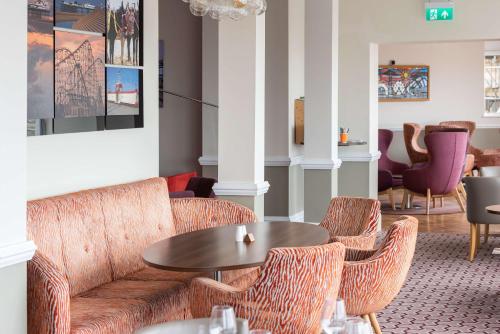 a living room with a couch and chairs and a table at Best Western Carlton Hotel in Blackpool