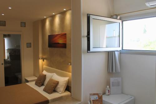a bedroom with a bed and a window at B&B Lizia in Porto Cesareo